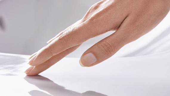 Hand brushing over a smooth ceramic surface with Geberit KeraTect Hand brushing over a smooth ceramic surface with Geberit KeraTect