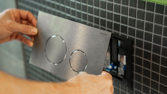 The actuator plate is the only visible part of the Geberit concealed cistern and is mounted directly onto the wall in front of the cistern