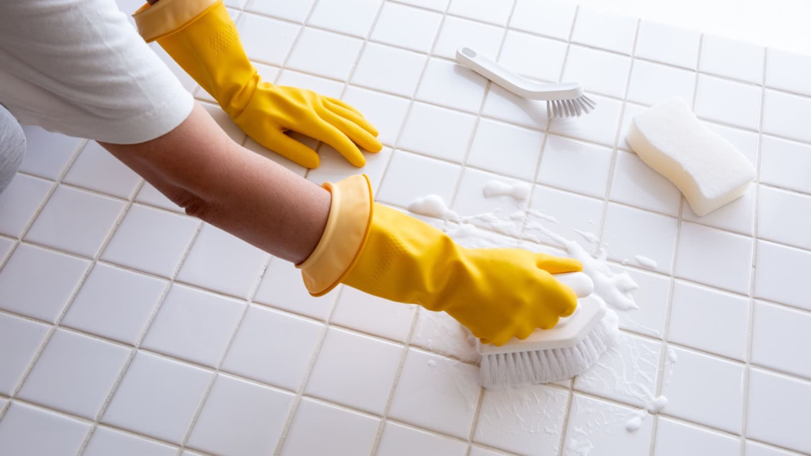 Woman scrubbing bathroom floor Woman scrubbing bathroom floor